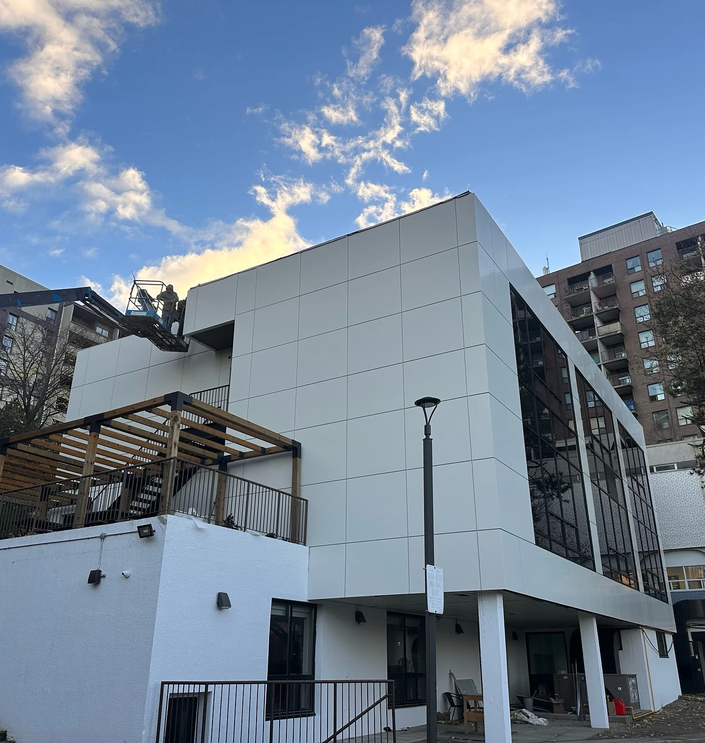 Completed silver ACM panel exterior with clean panel joints and glass facade